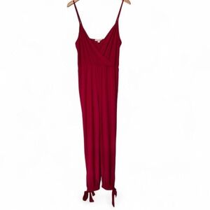 Red wrap style jumpsuit in deep red with tie detail at ankle by Rolla Costa M